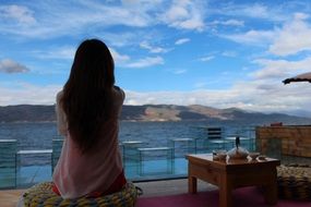 girl enjoys relaxing on the hotel terrace