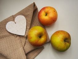 fresh apples with a loth and paper heart