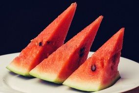 three slices of fresh red watermelon