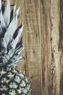 part of pineapple fruit on wooden background