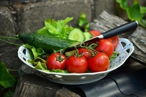 fresh Italian tomatoes with cucumbers in a bowl