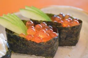 japanese sushi with avacado, seaweed, and fish eggs