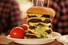 extremely large beef cheeburger with tomatoes