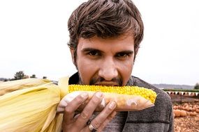 man eating corn