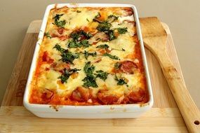 spanish national dis with baked cheese, eggs, tomatoes and more delicacy