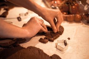 chef making moulds for gingerbread cookies