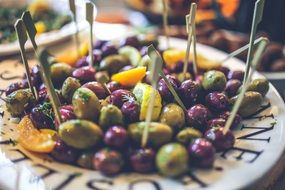 green and black olives on a plate