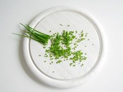 chopped chives on white board
