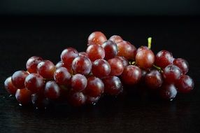 delicious and fresh grapes on black background
