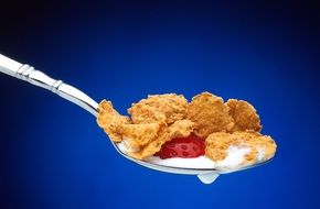 cereal and strawberry on a spoon