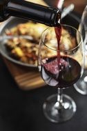 pour red wine into a glass
