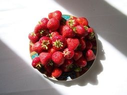 red ripe strawberries on a plate