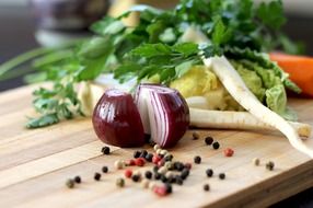 red onion and other vegetables on a cutting board