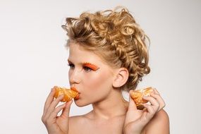 portrait of a woman eating oranges