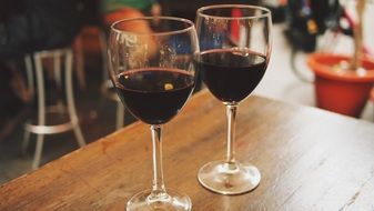 two red wine glasses on a table