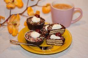 cakes are on a plate and tea cup