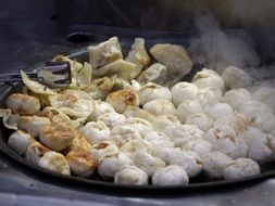 Chinese dumplings in a large pan