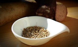 Photo of caraway seeds in a white bowl