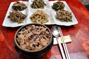 ogokbap and different types of meat on the table in a Korean restaurant