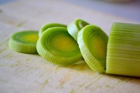 Macro photo of green organic leek on the board