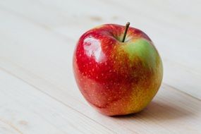 ripe red apple on wooden background