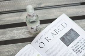 book and drink in a bottle in black and white