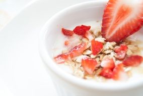 strawberries muesli in white cup