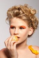 beautiful model eating orange