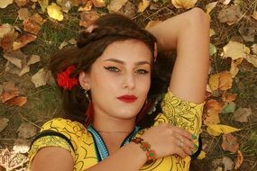 beautiful girl of the background of the autumn leaves