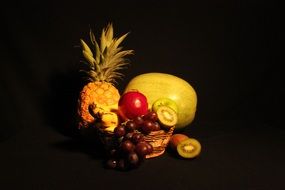 tropical fruits at black background