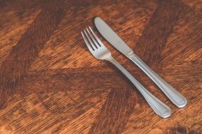 knife and fork on a wooden table