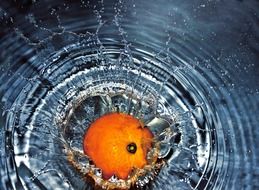 orange falling into the water with splash