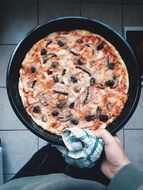 pizza with olives in a pan