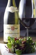 salad on the background of a glass of wine