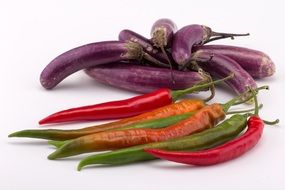 chili pepper next to eggplant