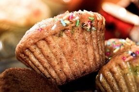 closeup view of sprinkled sweet muffins in pastry shop