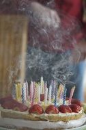 smoky blown out candles on birthday cake