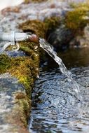 water fountain stone with a moss