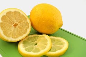 Lemon and lemon slices on the green board