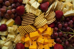 cheese plate with crackers and fruits