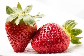 two strawberries on a white background