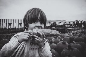 boy eating earcorn october