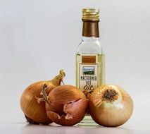 three onions and a bottle of oil