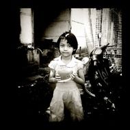 cute asian child girl ho;ding piece of watermelon