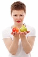 girl holding a pear and an Apple