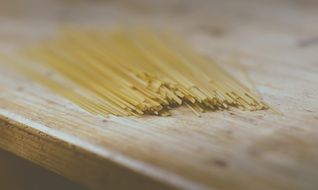 Raw spaghetti pasta on a wooden table