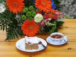 tea , cake and bouquet of flowers