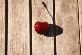 ripe cherries on a wooden surface