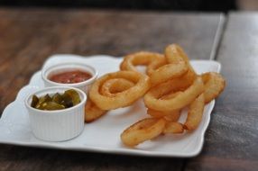 fried onion rings with sauce on a plate