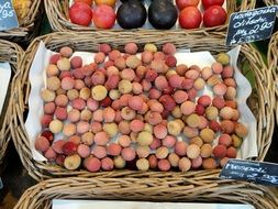 ripe lychees in a basket on a market in Germany